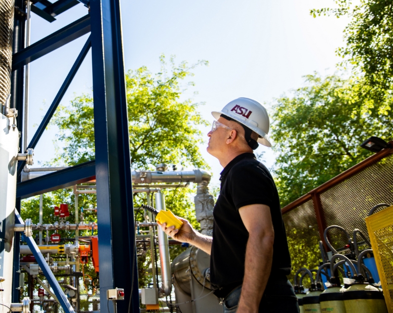 man with hard hat working on machinery
